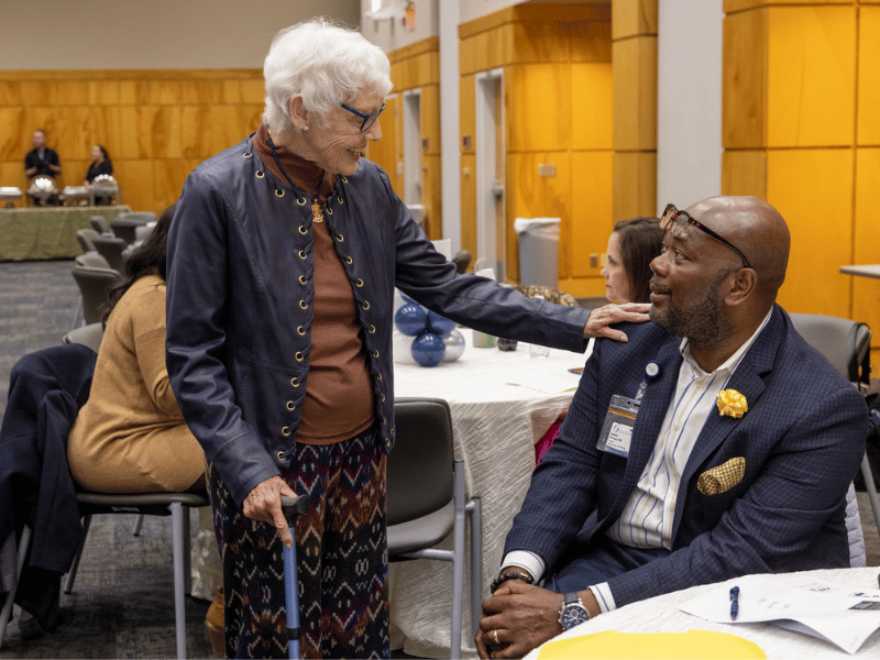 Professor emeritus Jeanette Waits greets Dr. Audwin Fletcher, assistant dean for graduate programs at the UMMC School of Nursing.